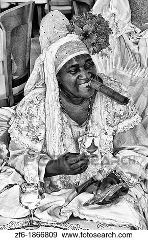 Woman with big cigar reading tallow cards of Santeria Religion cult dressed in white in Havana Cuba Habana View Large Photo Image Stock Photo - Woman with big cigar reading tallow cards of Santeria Religion cult dressed in white in Havana Cuba Habana. Fotosearch