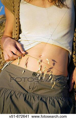 Woman with branch of cereal in her belly View Large Photo Image Stock Image - Woman with branch of cereal in her belly. Fotosearch