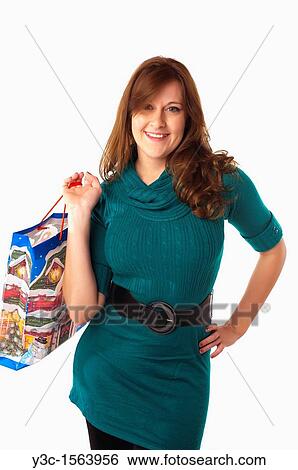 Woman with Christmas theme shopping bag View Large Photo Image Stock Photograph - Woman with Christmas theme shopping bag. Fotosearch