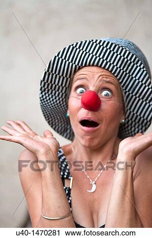 Woman with clown nose making faces View Large Photo Image Stock Image - Woman with clown nose making faces. Fotosearch