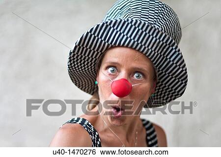 Woman with clown nose making faces View Large Photo Image Stock Photograph - Woman with clown nose making faces. Fotosearch