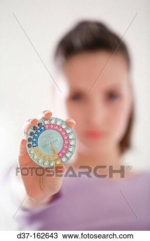 Stock Image - Woman with contraceptive pills. Fotosearch