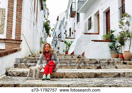 Woman with dog in Frigiliana, MBlaga, Andalucia, Spain View Large Photo Image Stock Photo - Woman with dog in Frigiliana, MBlaga, Andalucia, Spain. Fotosearch