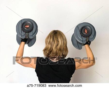 Stock Image - Woman with dumbbells. Fotosearch
