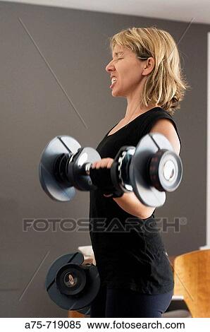 Woman with dumbbells View Large Photo Image Stock Photography - Woman with dumbbells. Fotosearch