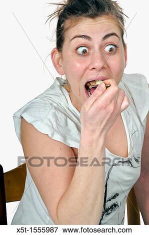 Woman with eyes wide open eats cream cake View Large Photo Image Stock Photo - Woman with eyes wide open eats cream cake. Fotosearch