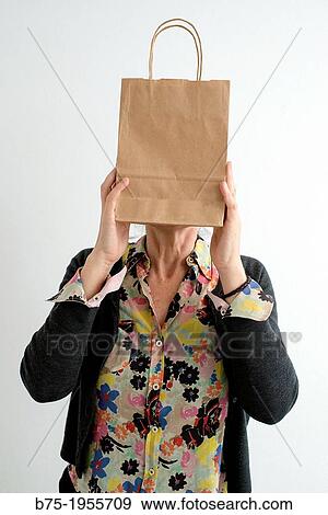Stock Photo - Woman with face covered with a paper bag. Fotosearch
