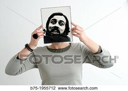 Woman with face covered with a photograph of a bearded man in black and white View Large Photo Image Stock Image - Woman with face covered with a photograph of a bearded man in black and white. Fotosearch