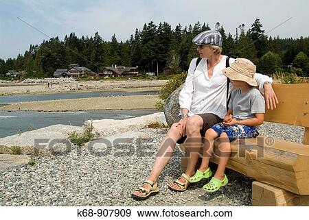 Stock Photo - woman with five year old boy on bench at Roberts Creek, BC, Canada. Fotosearch