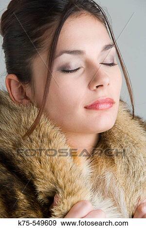 Stock Photo - woman with fur around her neck. Fotosearch