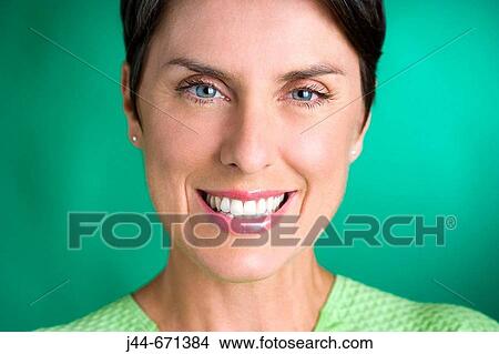 Picture - Woman with green shirt smiling, Portrait, close-up. Fotosearch