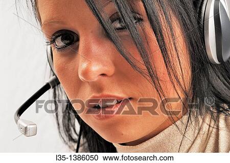Stock Image - Woman with headset. Fotosearch