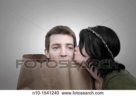 Woman with her husband, who is in a paper bag View Large Photo Image Stock Image - Woman with her husband, who is in a paper bag. Fotosearch