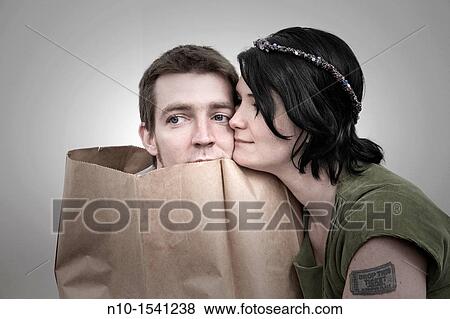 Woman with her husband, who is in a paper bag View Large Photo Image Stock Photo - Woman with her husband, who is in a paper bag. Fotosearch