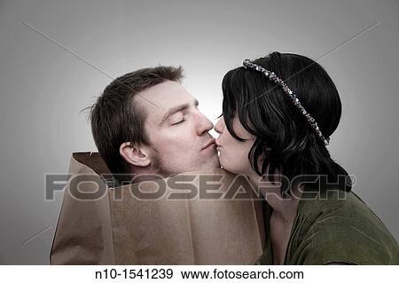 Woman with her husband, who is in a paper bag View Large Photo Image Stock Photo - Woman with her husband, who is in a paper bag. Fotosearch