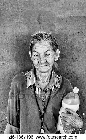 Woman with her ration milk from government on first of month in small town outside of Havana Cuba View Large Photo Image Stock Photograph - Woman with her ration milk from government on first of month in small town outside of Havana Cuba. Fotosearch