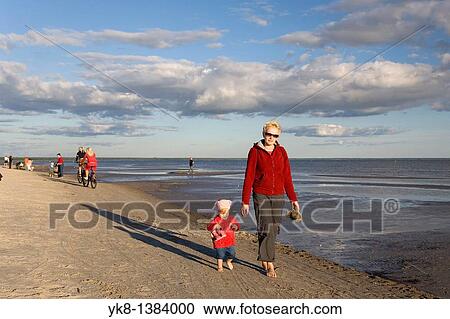 Woman with Kid in Red Clothes Walking Hand in Hand on P? rnu Beach in Estonia, Europe View Large Photo Image Stock Image - Woman with Kid in Red Clothes Walking Hand in Hand on P? rnu Beach in Estonia, Europe. Fotosearch
