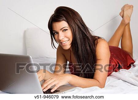 Woman with laptop in bed View Large Photo Image Stock Photo - Woman with laptop in bed. Fotosearch