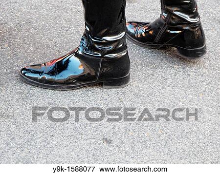Woman with leather boots walking in street View Large Photo Image Stock Photo - Woman with leather boots walking in street. Fotosearch