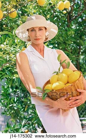 Woman with lemons View Large Photo Image Stock Image - Woman with lemons. Fotosearch