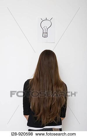 Stock Photo - Woman with light bulb symbol. Fotosearch