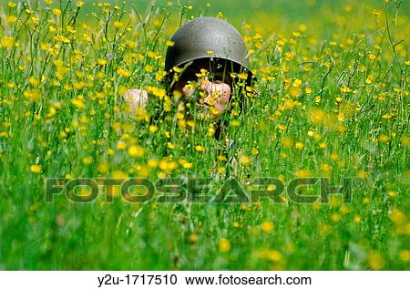 Woman with military helmet in the field with yellow flowers View Large Photo Image Stock Image - Woman with military helmet in the field with yellow flowers. Fotosearch