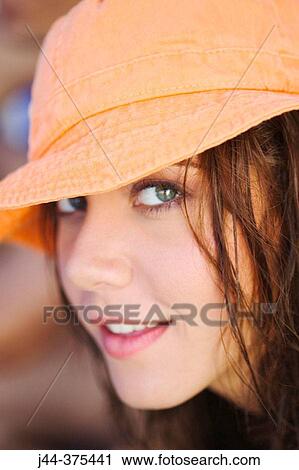 Woman with orange hat portrait View Large Photo Image Stock Image - Woman with orange hat portrait. Fotosearch