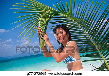 Stock Photography - Woman with palm. Krabi. Andaman Sea. Thailand. Fotosearch