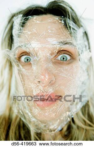 Woman with plastic on her face View Large Photo Image Stock Image - Woman with plastic on her face. Fotosearch
