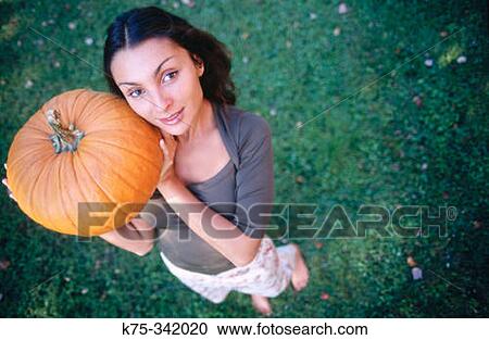 Woman with pumpkin View Large Photo Image Stock Image - Woman with pumpkin. Fotosearch