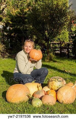 Stock Photograph - Woman with pumpkins.. Fotosearch
