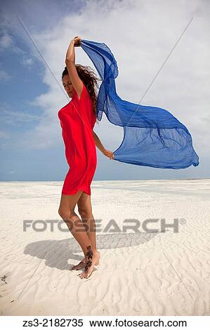 Woman with red dress on the beach, Jambiani, Zanzibar, Tanzania, East Africa. View Large Photo Image Stock Photography - Woman with red dress on the beach, Jambiani, Zanzibar, Tanzania, East Africa.. Fotosearch