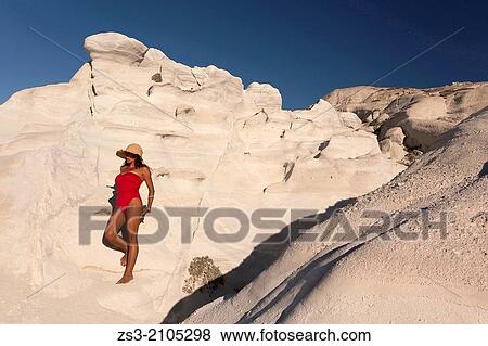 Woman with red swimsuit posing near the white rock forms in Sarakiniko beach, Milos, Cyclades Islands, Greek Islands, Greece, Europe. View Large Photo Image Stock Photo - Woman with red swimsuit posing near the white rock forms in Sarakiniko beach, Milos, Cyclades Islands, Greek Islands, Greece, Europe.. Fotosearch