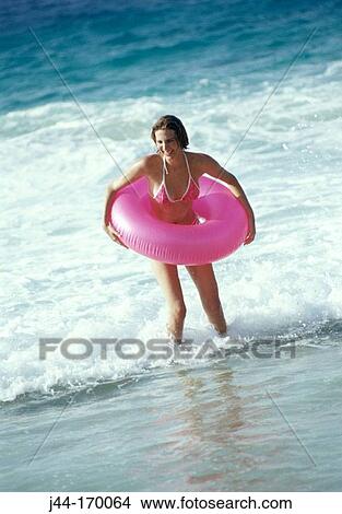 Woman with rubber ring around waist in the beach View Large Photo Image Picture - Woman with rubber ring around waist in the beach. Fotosearch