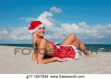 Woman with Santa's hat on the beach, Miami, Florida, USA View Large Photo Image Picture - Woman with Santa's hat on the beach, Miami, Florida, USA. Fotosearch