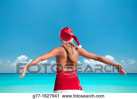Woman with Santa's hat on the beach, Miami, Florida, USA View Large Photo Image Stock Image - Woman with Santa's hat on the beach, Miami, Florida, USA. Fotosearch