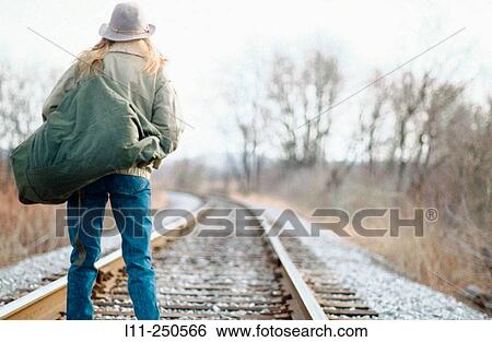 Woman with seabag on the rail road tracks View Large Photo Image Stock Photograph - Woman with seabag on the rail road tracks. Fotosearch