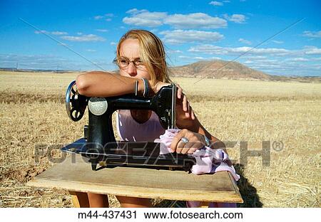 Woman with sewing machine View Large Photo Image Stock Image - Woman with sewing machine. Fotosearch