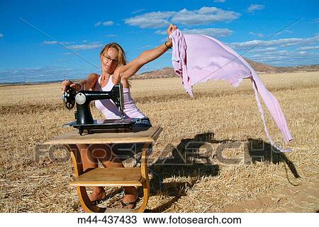 Woman with sewing machine View Large Photo Image Stock Image - Woman with sewing machine. Fotosearch