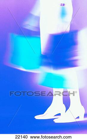 Stock Image - Woman with shopping bags, color negative image. Fotosearch