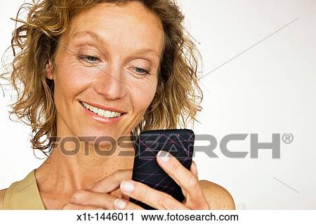 Stock Image - Woman with smartphone. Fotosearch