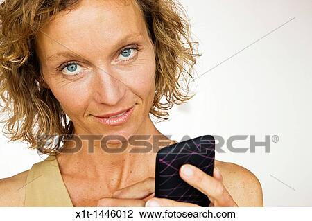 Stock Image - Woman with smartphone. Fotosearch