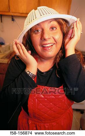 Picture - Woman with strainer on her head. Fotosearch