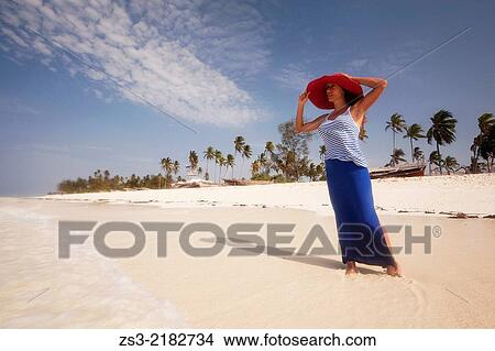 Woman with straw hat on the beach, Nungwi, Zanzibar, Tanzania, East Africa. View Large Photo Image Picture - Woman with straw hat on the beach, Nungwi, Zanzibar, Tanzania, East Africa.. Fotosearch