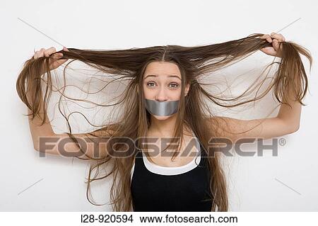 Picture - Woman with Tape Over Mouth. Fotosearch