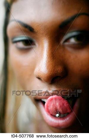 Stock Photo - Woman with tongue piercing. Fotosearch