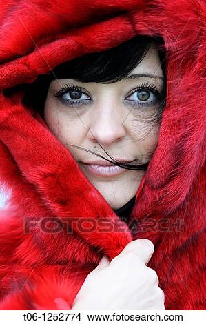 Woman with two different colored eyes and red coat Heterochromia iridium View Large Photo Image Picture - Woman with two different colored eyes and red coat Heterochromia iridium. Fotosearch