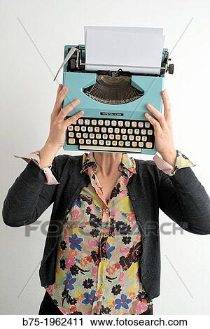 Woman with typewriter covering her face View Large Photo Image Stock Image - Woman with typewriter covering her face. Fotosearch