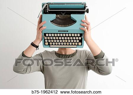 Woman with typewriter covering her face View Large Photo Image Stock Image - Woman with typewriter covering her face. Fotosearch