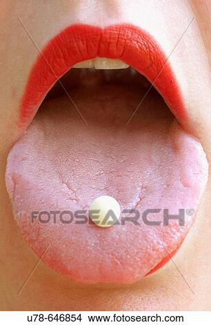 Woman with vitamin pill on tongue. View Large Photo Image Picture - Woman with vitamin pill on tongue.. Fotosearch